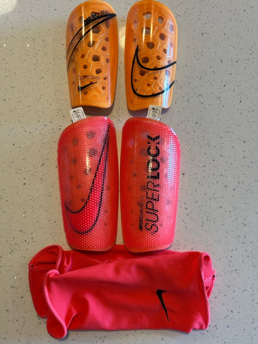 Nike Mercurial Superlock Shin Guards in Orange and Red